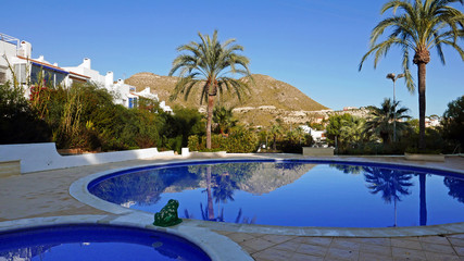 Swimming pool at a holiday village on the Costa Blanca in Spain - obrazy, fototapety, plakaty