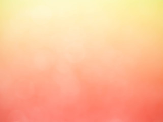 Golden and pink background with soft bokeh lights.