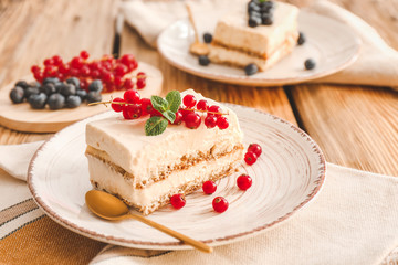 Plate with tasty tiramisu on table