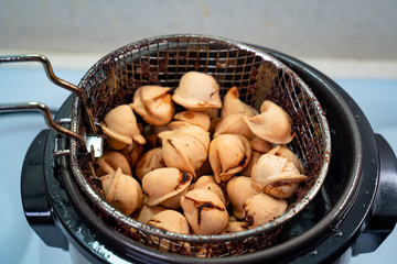 ready dumplings cooked in boiling oil fryer basket