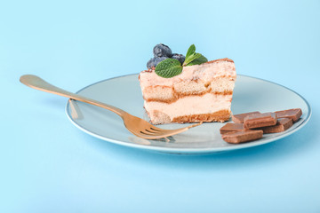 Plate with tasty tiramisu on color background