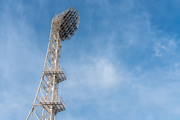 The floodlights at the stadium, afternoon, blue sky background.