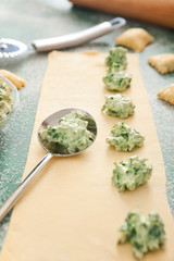 Preparing of tasty ravioli on color background