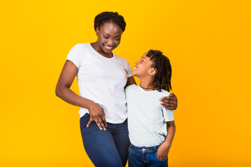 Black mother posing with her happy kid