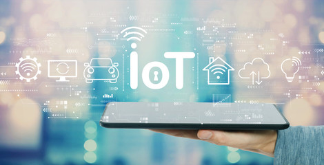 IoT theme with man holding a tablet computer