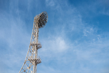 The floodlights at the stadium, afternoon, blue sky background.