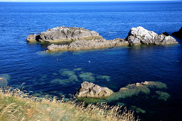 Portknockie (Scotland), UK - August 01, 2018: Coastal landscape at Bow Fiddle Rock sea arch, Portknockie, Scotland, Highlands, United Kingdom