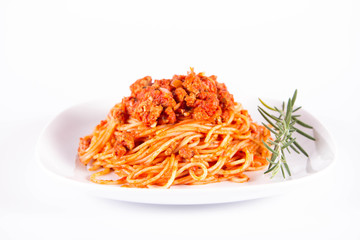 Spaghetti bolognese on a plate	 decorated with a rosemary twig