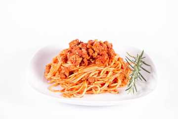 Spaghetti bolognese on a plate	 decorated with a rosemary twig