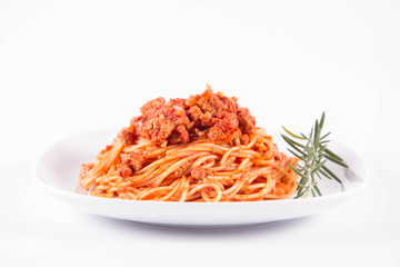 Spaghetti bolognese on a plate	 decorated with a rosemary twig