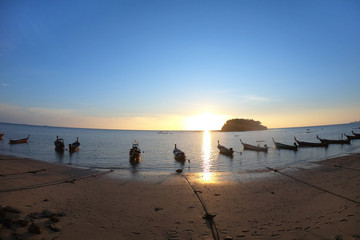 Fototapeta na wymiar wooden longtail boat and beautiful sand beach at sunset.
