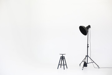 Wooden chair with lighting equipment isolated on a white background. Space for text. Vacant chair....