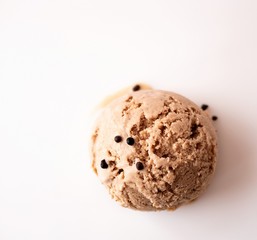 Vegan oatmeal milk ice cream ball with chocolate chips on a light background with space for text. Top view. Flat lay
