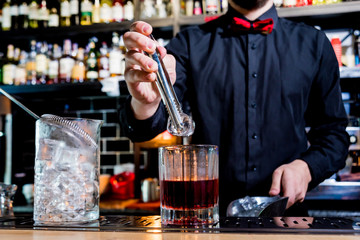 Bartender is making cocktail at bar counter. Fresh cocktails. 