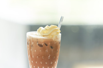 cold tea  or coffee frappe with whip cream with stirrer