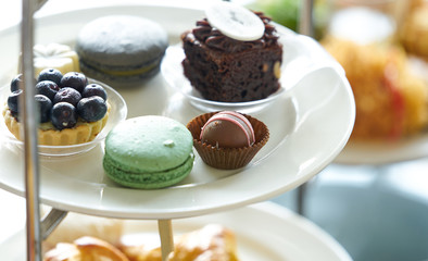 blue berry tart,macaron ,brownie,chocolate ball on plate stand