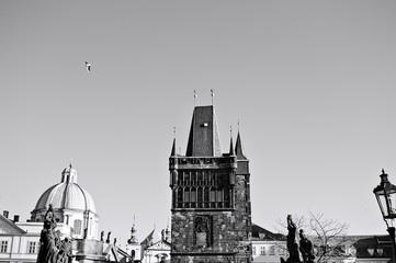 View of the Charles Bridge Tower and the statues on the Charles Bridge (Prague, Czech Republic, Europe)