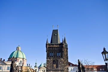 View of the Charles Bridge Tower and the statues on the Charles Bridge (Prague, Czech Republic, Europe)