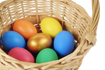 Colorful Easter eggs in the basket on the white background