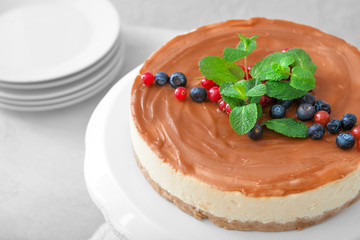 Tasty cheesecake with berries on table, closeup