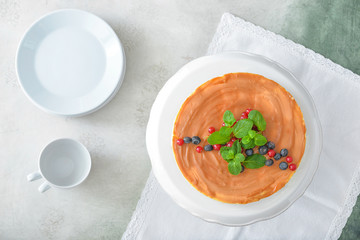 Tasty cheesecake with berries on color background