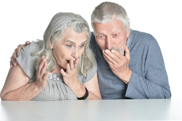 Portrait of surprised happy senior couple isolated on white background