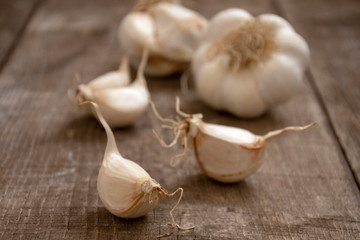 Closeup of a group of a fresh garlic on a rustic wood table, selective focus.