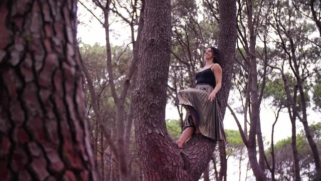 A Lady In A Black Dress Casually Leaning On The Branch Of The Tree Making A Peace Sign In Centennial Park In Sydney, Australia. -wide  shot