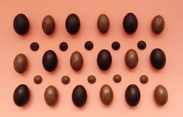 Several chocolate eggs on a peach background in a separate pattern