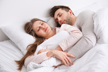 Young couple sleeping in bed