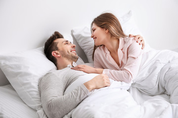 Morning of young couple in bed