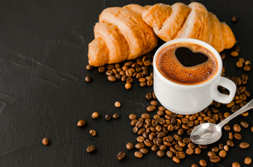 Coffee white cup, croissants on dark  background. Breakfast concept