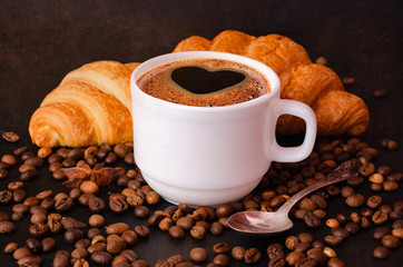 Coffee white cup, croissants on dark  background. Breakfast concept