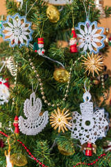 Decorated Christmas tree. Toys and lace snowflakes. New year.