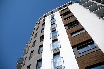 Urban lifestyle. Facade of new modern residential house. Apartment building in the city. 