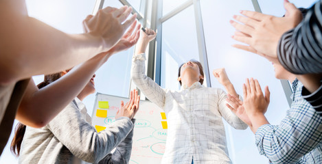 smart asian business male leader in a casual meeting with his teamwork colleagues at the modern desogn office presenting sales strategy plan and data or forecast for a project goal schedule