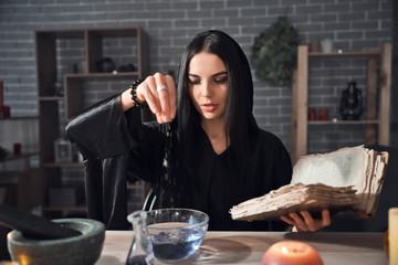 Female alchemist making elixir in laboratory