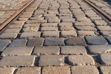 Street made of cobblestone. Granite cubes.