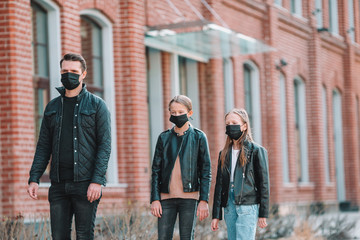 People wearing a mask on a background of a modern building,