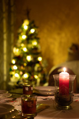 Christmas tree in gold colors in classic dark room. A magical atmosphere.