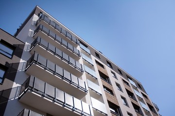 Urban lifestyle. Facade of new modern residential house. Apartment building in the city. 