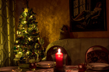 Christmas tree in gold colors in classic dark room. A magical atmosphere.