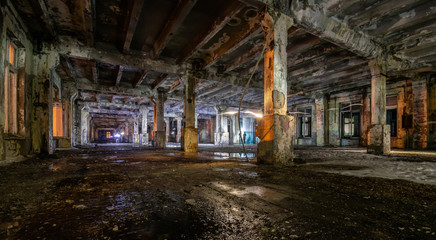 Interior of an old abandoned soviet building with cracked ragged walls and leaking roof and wet...
