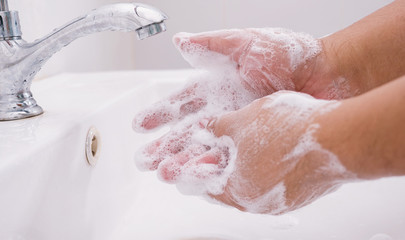 washing hands by soap for safety from corona virus