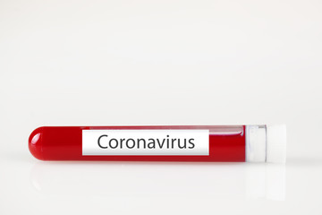 Test tube with blood and white sticker on white. Background with copy space. Coronavirus. Horizontal.