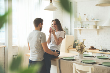 Lifestyle consept at home with couple young men and woman in kitchen