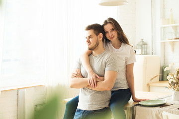 Lifestyle consept at home with couple young men and woman in kitchen