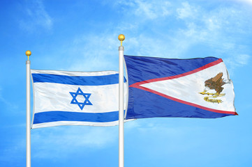 Israel and American Samoa two flags on flagpoles and blue cloudy sky