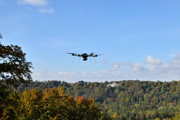 black flying drone in sky