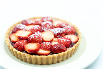 Strawberry tart shot in studio on white background